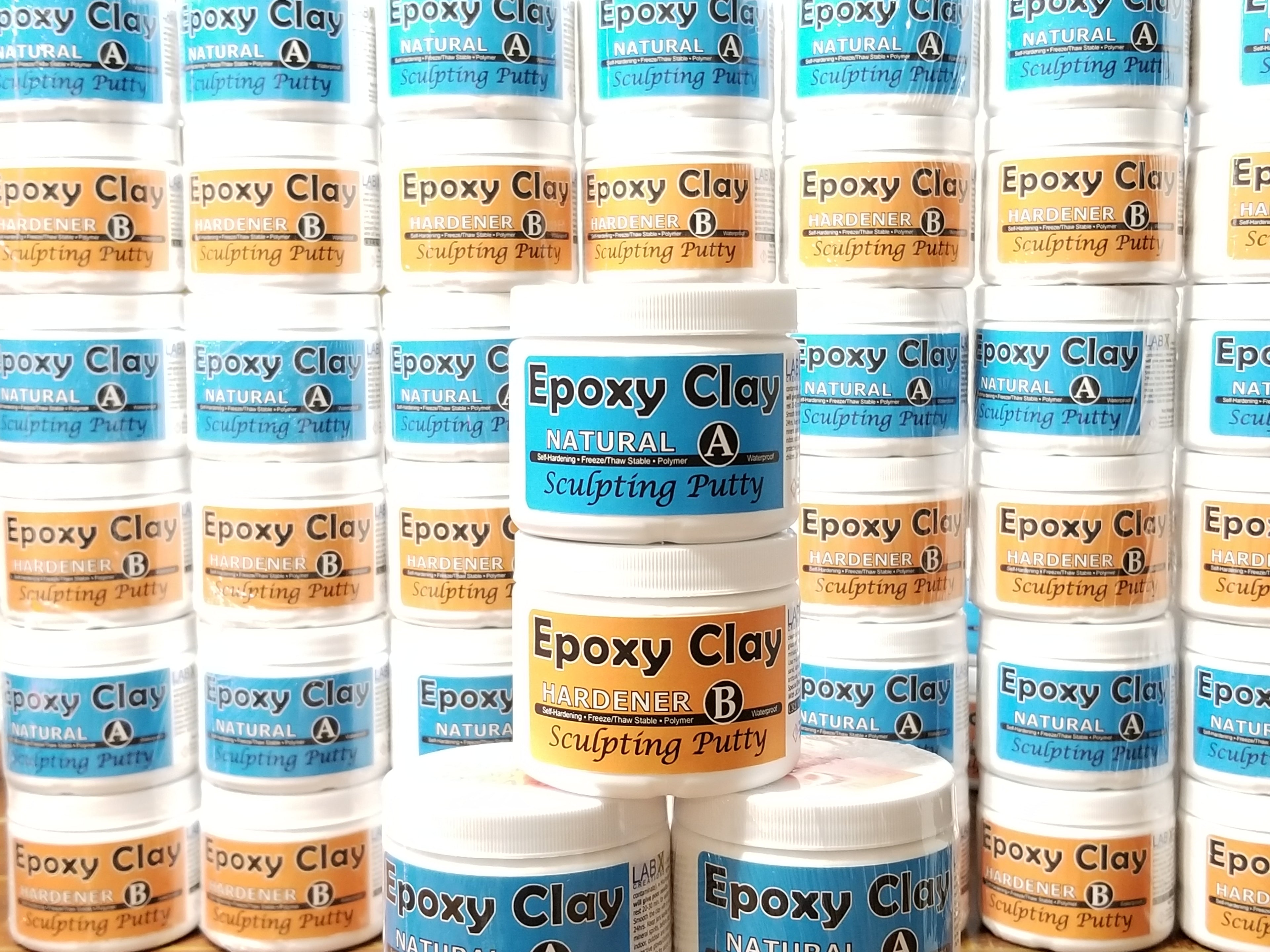 Multiple bottles of Epoxy Clay A and B with labels on a white bottles.